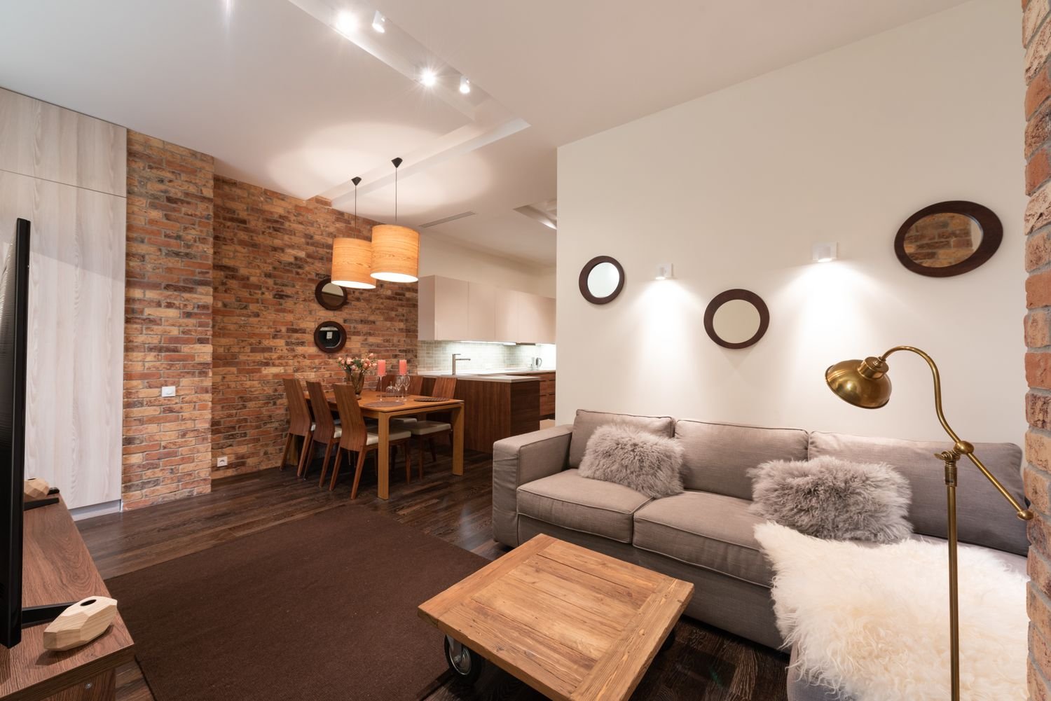 A warm, well-kept interior space with exposed brick, clean lines and soft lighting