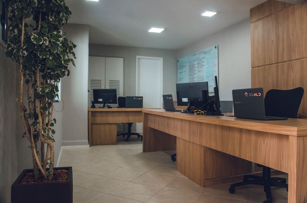 A clean, modern office with tidy wooden desks
