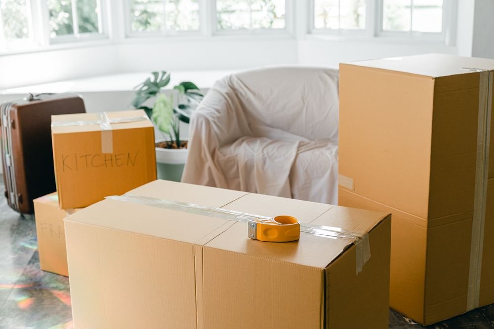 Labelled moving boxes in a bright, freshly cleaned room