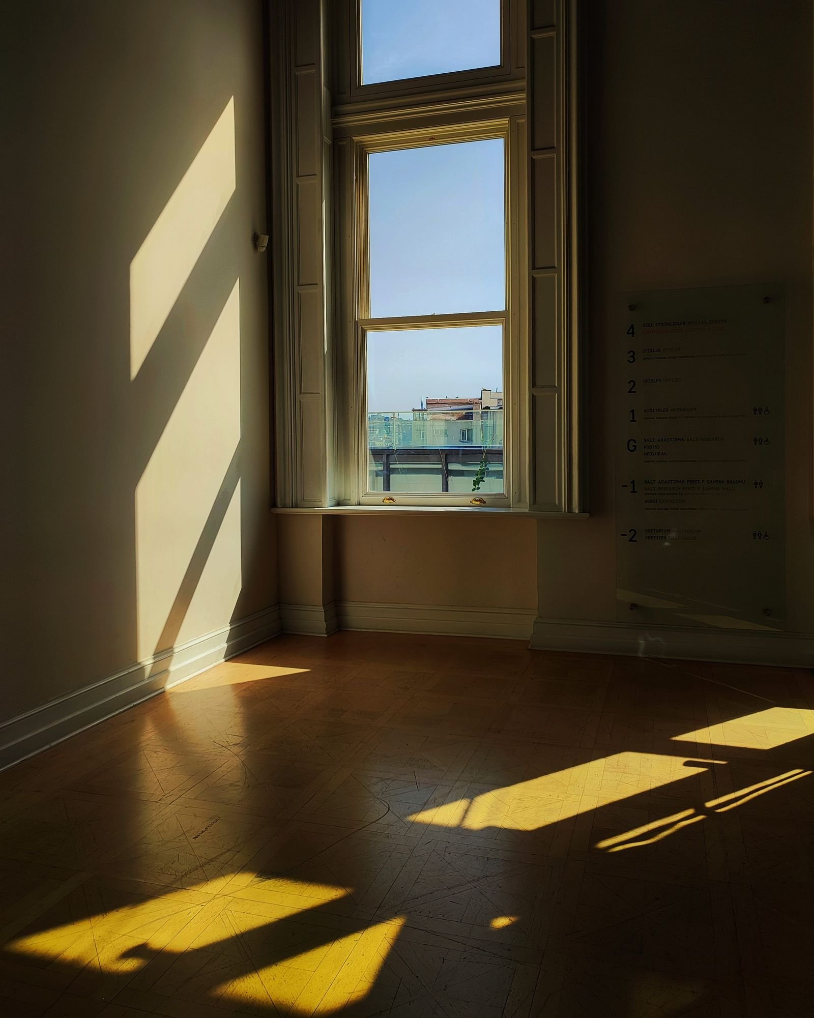 Warm afternoon sunlight pouring across a clean wooden floor